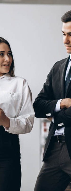Male and female business people working on tablet in office